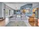 Open living space with wood floors, access to a deck, and view to a kitchen with breakfast bar at 248 Copperdale Ln, Golden, CO 80403