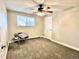 Neutral bedroom with large window providing natural light and ceiling fan at 4816 W 8Th Ave, Denver, CO 80204