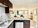 Kitchen open to the living room featuring a breakfast bar and stainless steel appliances at 4816 W 8Th Ave, Denver, CO 80204