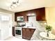 Updated kitchen featuring stainless steel appliances, granite countertops, and dark wood cabinets at 4816 W 8Th Ave, Denver, CO 80204