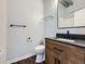 Stylish bathroom featuring modern fixtures, a floating glass shelf, and vanity with storage space at 2501 15Th St # 3D, Denver, CO 80211