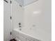 A bright bathroom with a white tiled tub/shower combination and modern fixtures at 2501 15Th St # 3D, Denver, CO 80211