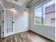 Inviting bedroom with hardwood floors and large windows offering natural light and neighborhood views at 2501 15Th St # 3D, Denver, CO 80211