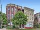 Attractive building exterior featuring unique architectural details, large windows, and mature trees at 2501 15Th St # 3D, Denver, CO 80211