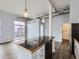 A contemporary kitchen with industrial style lighting, dark countertops, and stainless steel appliances at 2501 15Th St # 3D, Denver, CO 80211