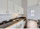 A functional kitchen space with dark countertops, stainless appliances and light cabinets at 2501 15Th St # 3D, Denver, CO 80211
