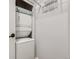 Laundry area with a stackable washer and dryer, along with white wire shelving for storage at 2501 15Th St # 3D, Denver, CO 80211