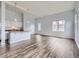 Bright living room with open floor plan, modern lighting, and wood-style floors at 2501 15Th St # 3D, Denver, CO 80211