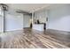 Open living area with island, stainless steel appliances, and wood floors at 2501 15Th St # 3D, Denver, CO 80211