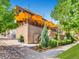 Beautiful outdoor patio with several large umbrellas, landscaping, and a sidewalk at 2501 15Th St # 3D, Denver, CO 80211
