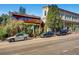 Charming buildings with vintage brick exteriors, lush landscaping, and street parking along a city street at 2501 15Th St # 3D, Denver, CO 80211