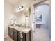 Bathroom with granite countertop and dark brown vanity at 6829 Juniper Ct, Frederick, CO 80530