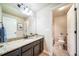 Bathroom with granite countertop, dark brown vanity, and toilet at 6829 Juniper Ct, Frederick, CO 80530