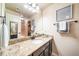 Bathroom with granite countertop, dark brown vanity, and mirror at 6829 Juniper Ct, Frederick, CO 80530