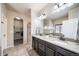 Elegant bathroom with double sinks, granite counters, and a walk-in shower at 6829 Juniper Ct, Frederick, CO 80530