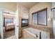 Relaxing bathroom with soaking tub, fireplace, and bedroom view at 6829 Juniper Ct, Frederick, CO 80530