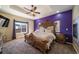 Main bedroom with ornate bed frame and purple accent wall at 6829 Juniper Ct, Frederick, CO 80530