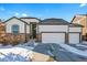 Two-story house with a three-car garage and stone accents at 6829 Juniper Ct, Frederick, CO 80530