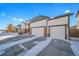 Two-story house with a three-car garage and snowy front yard at 6829 Juniper Ct, Frederick, CO 80530