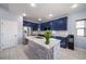 Modern kitchen with blue cabinets, marble island, and stainless steel appliances at 6829 Juniper Ct, Frederick, CO 80530