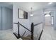 Modern staircase with dark wood railings and white spindles at 6829 Juniper Ct, Frederick, CO 80530