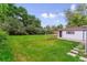 A spacious backyard with green grass and a detached garage at 1815 Ingalls St, Lakewood, CO 80214