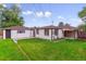 A well-maintained backyard featuring a detached garage and patio at 1815 Ingalls St, Lakewood, CO 80214