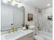 Well-lit bathroom featuring modern fixtures, tiled shower, and decorative elements at 1815 Ingalls St, Lakewood, CO 80214