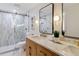 Beautiful bathroom with a walk-in shower, marble countertops, and modern fixtures at 1815 Ingalls St, Lakewood, CO 80214