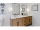 Bright bathroom featuring double sinks, marble countertops, and modern lighting at 1815 Ingalls St, Lakewood, CO 80214