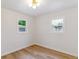 Simple bedroom with wood floors, white walls, and natural light from two windows at 1815 Ingalls St, Lakewood, CO 80214