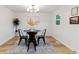 Minimalist dining room featuring hardwood floors, modern black chairs, and contemporary lighting fixture at 1815 Ingalls St, Lakewood, CO 80214