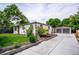 Beautiful home with a long driveway, detached garage, and well-manicured landscaping and garden at 1815 Ingalls St, Lakewood, CO 80214