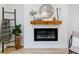 Close up shot of an electric fireplace feature with decor, a wooden mantle and hearth at 1815 Ingalls St, Lakewood, CO 80214