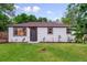 Charming single-story home with white siding, a well-maintained lawn, and freshly landscaped flower beds at 1815 Ingalls St, Lakewood, CO 80214