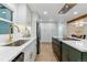 A modern kitchen with white cabinets, stainless steel appliances, and an island with seating at 1815 Ingalls St, Lakewood, CO 80214