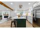 Modern kitchen with a central island, stainless appliances, and an adjacent living area with fireplace at 1815 Ingalls St, Lakewood, CO 80214