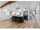 Spacious kitchen featuring white cabinets, stainless steel appliances, and a stylish island with seating at 1815 Ingalls St, Lakewood, CO 80214