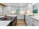Well-lit kitchen with white cabinets, stainless steel appliances, and a center island with a cooktop at 1815 Ingalls St, Lakewood, CO 80214