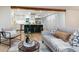 Open-concept living area with a view into the kitchen featuring a large island with bar seating at 1815 Ingalls St, Lakewood, CO 80214
