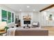 Bright living room with a fireplace, hardwood floors, and a neutral color palette, creating a relaxing ambiance at 1815 Ingalls St, Lakewood, CO 80214