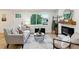 Cozy living room with a comfortable couch, stylish decor, and a fireplace, all illuminated by natural light at 1815 Ingalls St, Lakewood, CO 80214