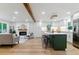 Open concept living area with modern kitchen, fireplace, and hardwood floors at 1815 Ingalls St, Lakewood, CO 80214