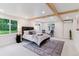 Spacious main bedroom with a large bed, ample natural light, and a cozy seating area at 1815 Ingalls St, Lakewood, CO 80214