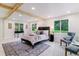 Bright main bedroom with windows, a cozy seating area, and stylish decor at 1815 Ingalls St, Lakewood, CO 80214