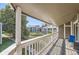 View from balcony overlooking community landscape with mature trees and nearby residential buildings on a sunny day at 18193 E Kentucky Ave # 203, Aurora, CO 80017