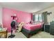 Pink bedroom with carpet features a neutral color window with gray curtains at 18193 E Kentucky Ave # 203, Aurora, CO 80017