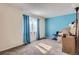 Bright room with blue accent wall, carpeted, and natural light from one window at 18193 E Kentucky Ave # 203, Aurora, CO 80017