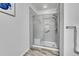 Modern bathroom with a walk-in shower and gray tile flooring at 8457 S Hoyt Way # 206, Littleton, CO 80128