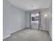 Bright bedroom with gray carpeting and large window at 8457 S Hoyt Way # 206, Littleton, CO 80128